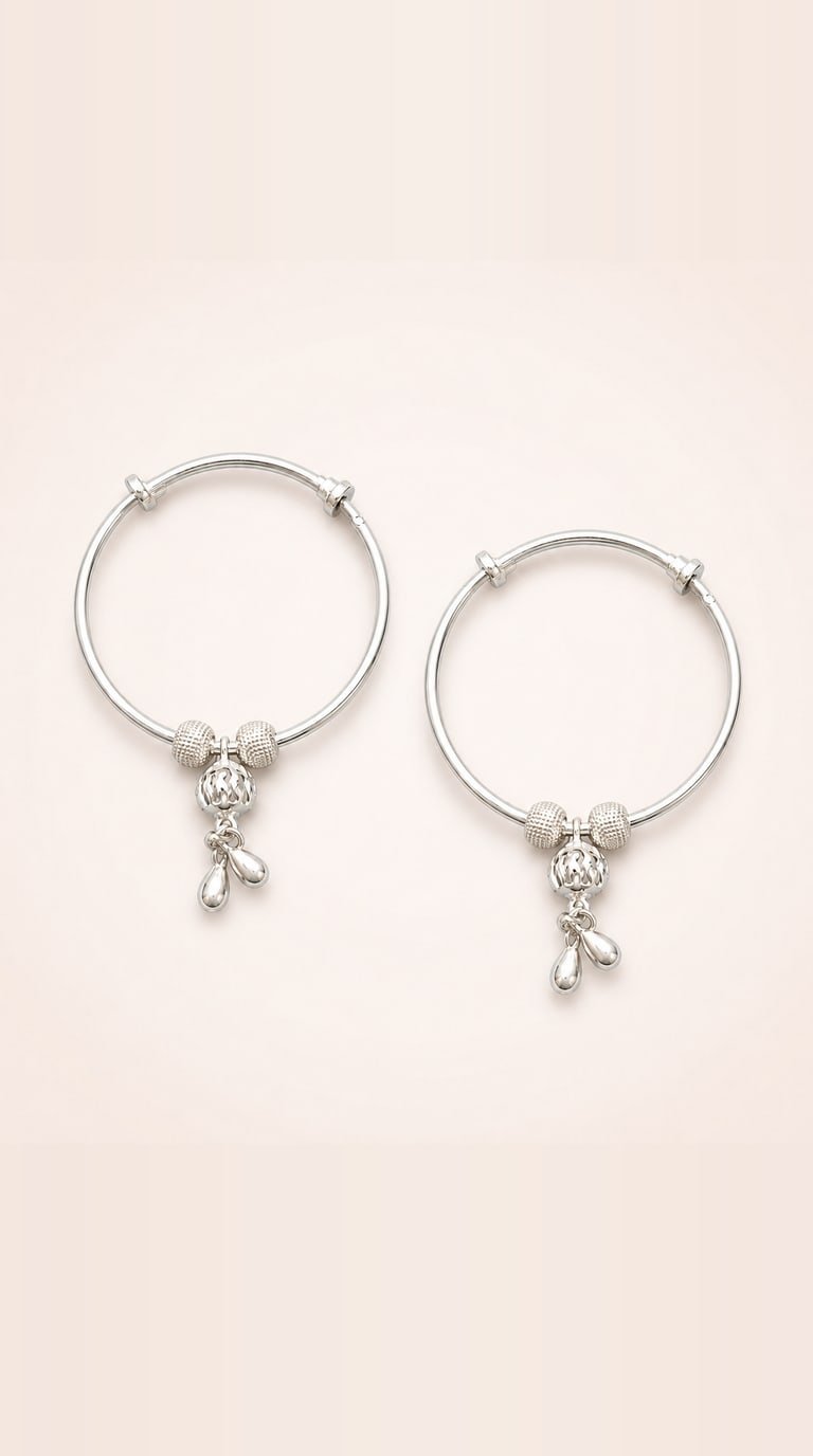 The girls' baby bangles shown at two sizes to show the sliding, adjustable fit