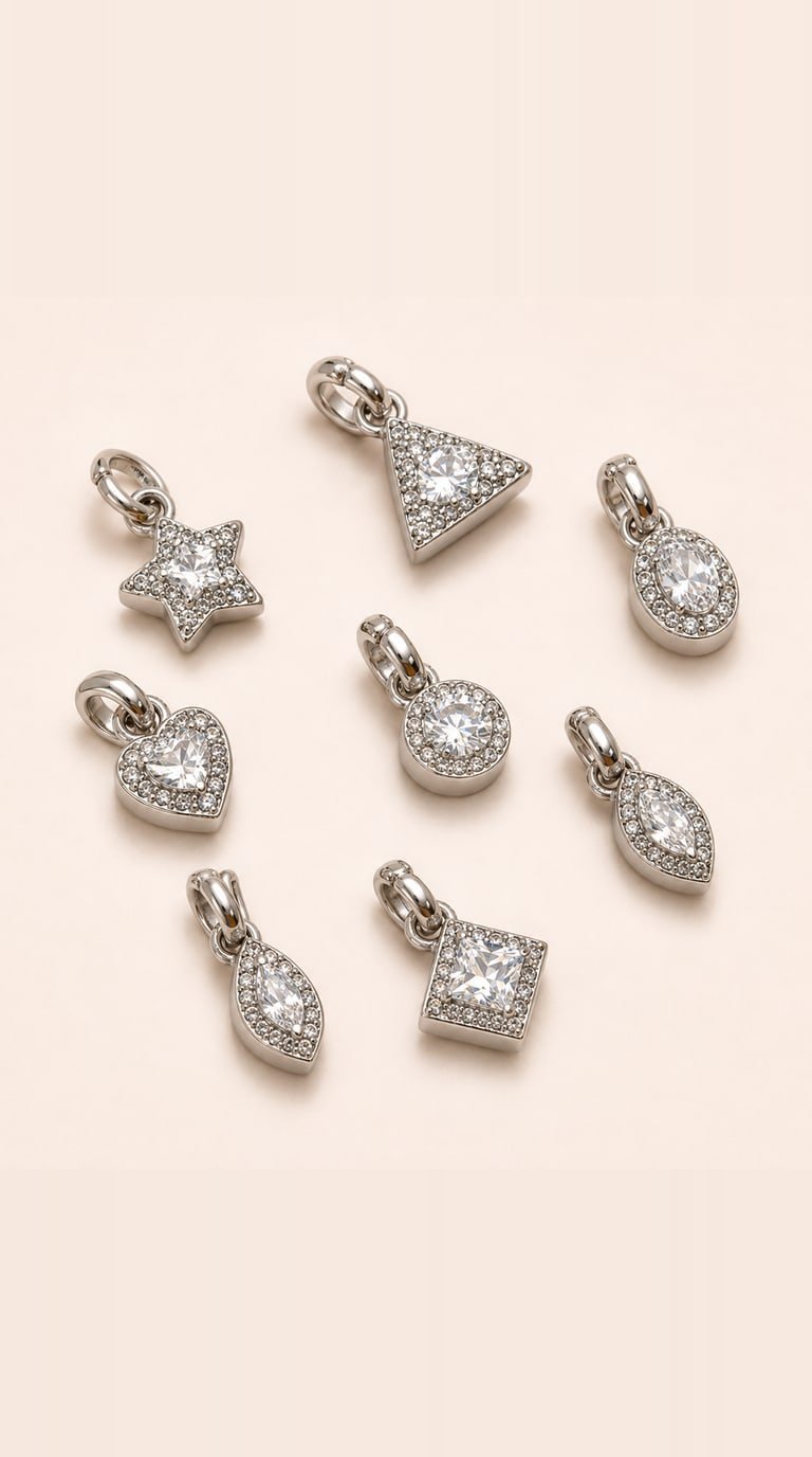 Eight sterling silver halo charm pendants in star, heart, triangle, square, round, oval, pear and marquise shapes