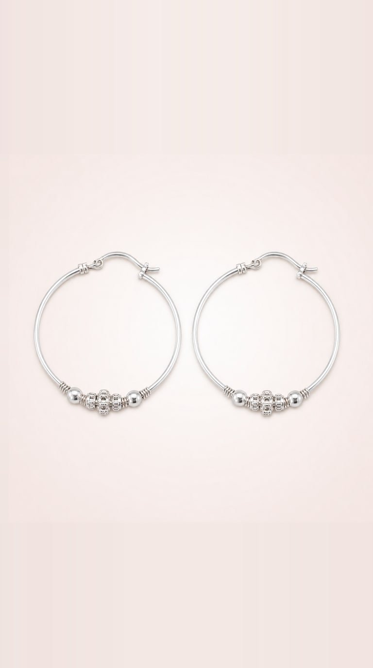 The silver baby bangles seen from the front, showing the bead cluster and sliding collars